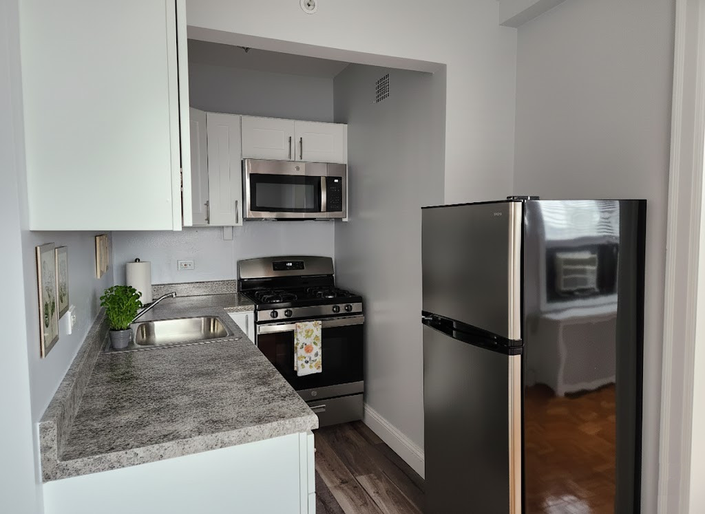 Modern small kitchen with stainless steel appliances.