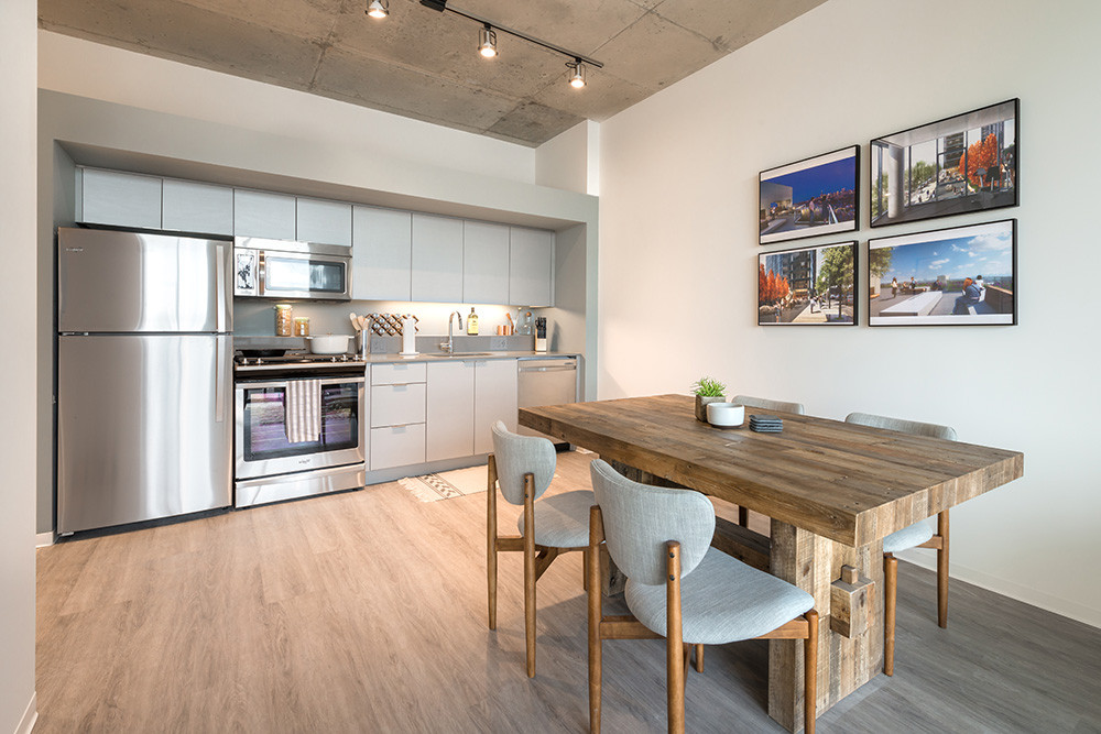 Modern kitchen with wooden dining table.