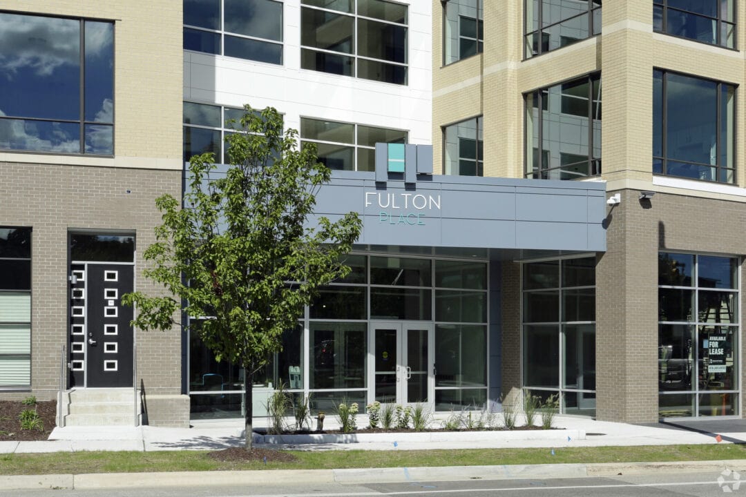 Modern office building entrance with signage.