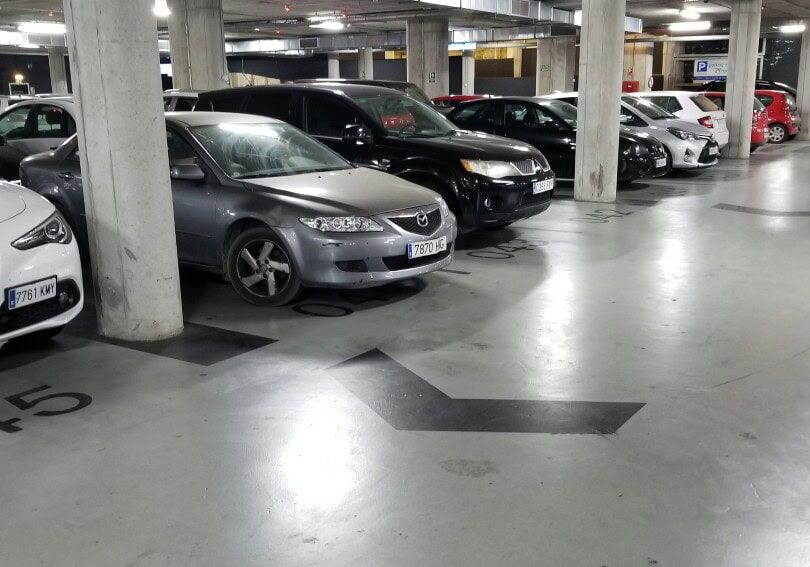 Underground parking garage with parked cars.