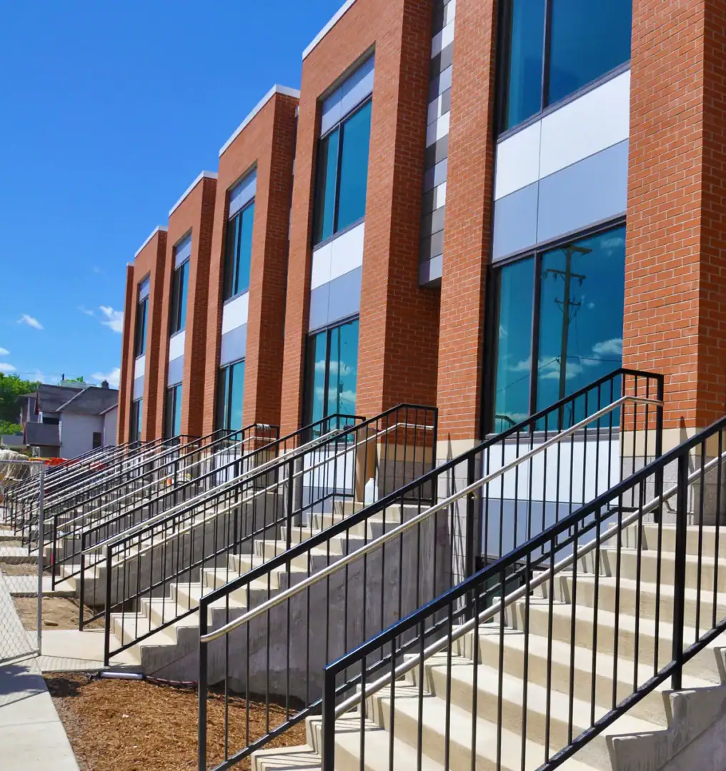Modern building with brick exterior and large windows.