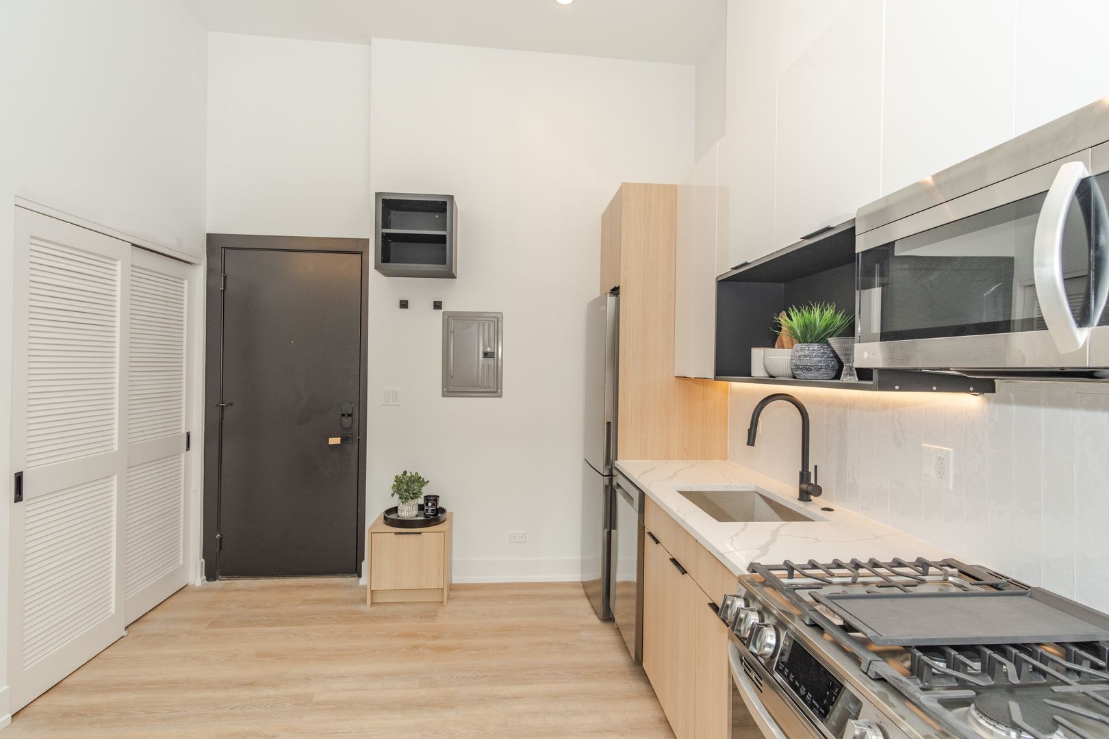 Modern kitchen with stainless steel appliances and wood accents.