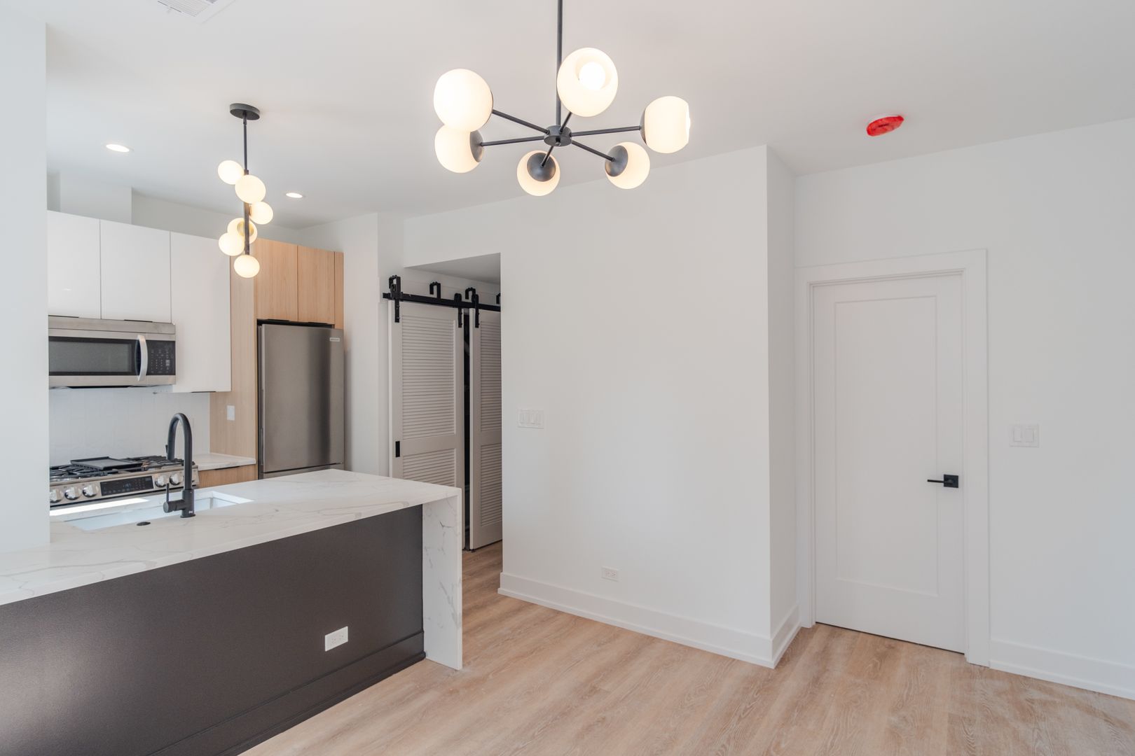 Modern apartment kitchen with island and stylish pendant lights