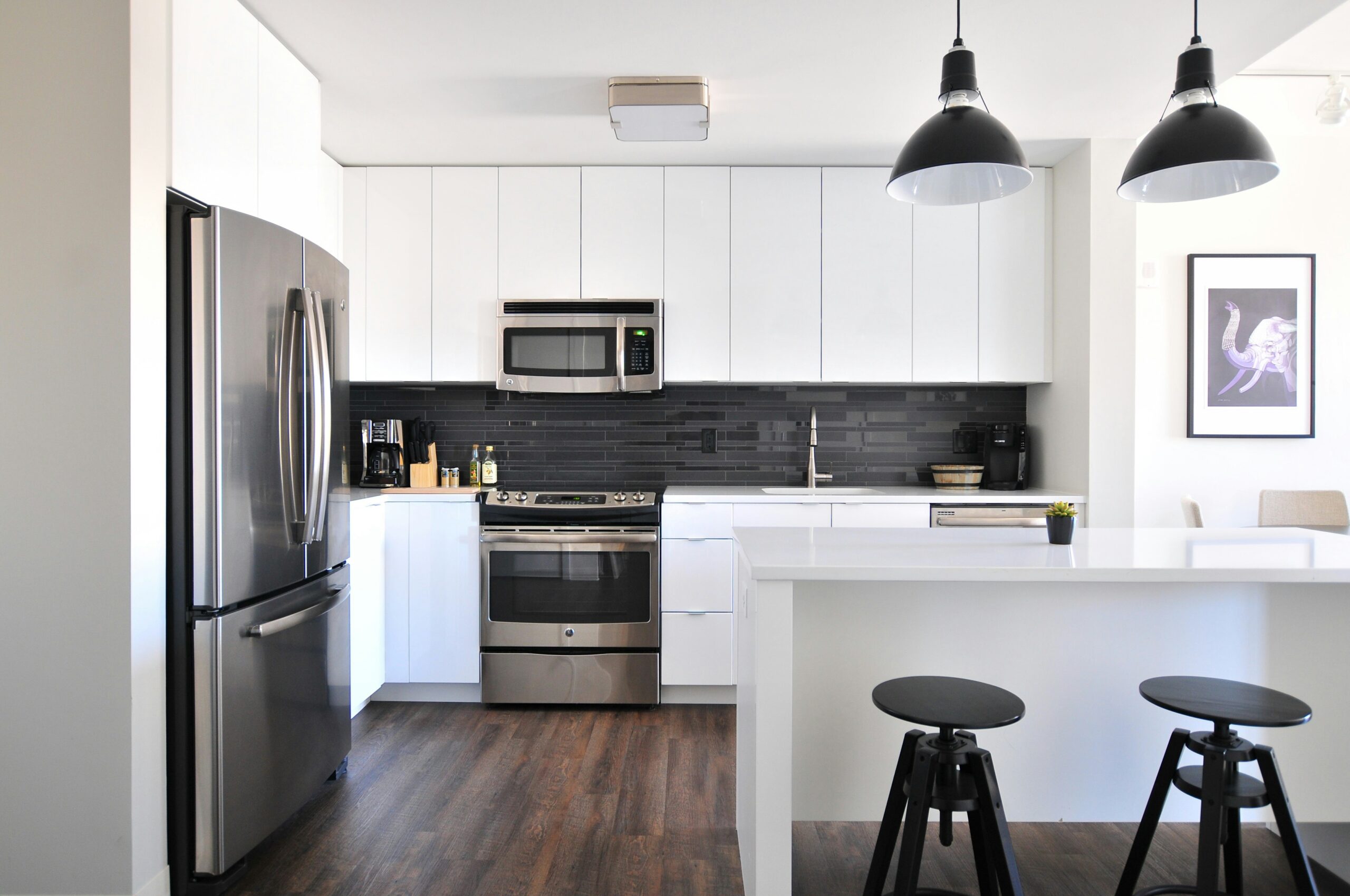 Modern kitchen with island and stainless steel appliances.